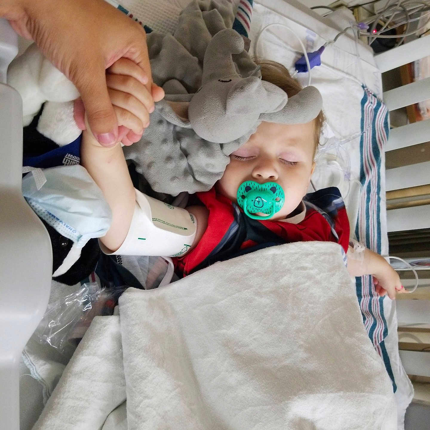 Jerecho is registered to the contest to win money with this photo: architecture, baby, bed, blanket, bodypart, building, clothing, crib, face, finger, furniture, glove, hand, head, homedecor, hospital, infantbed, person, photography, portrait