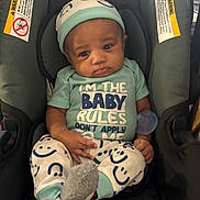 Dezyrion is registered to the contest to win money with this photo: baby, car_seat, infant, clothing, hat, pacifier, socks, person, face, expression, seated, comfort, smiley_faces, child, casual, indoor, cute, young, portrait, apparel