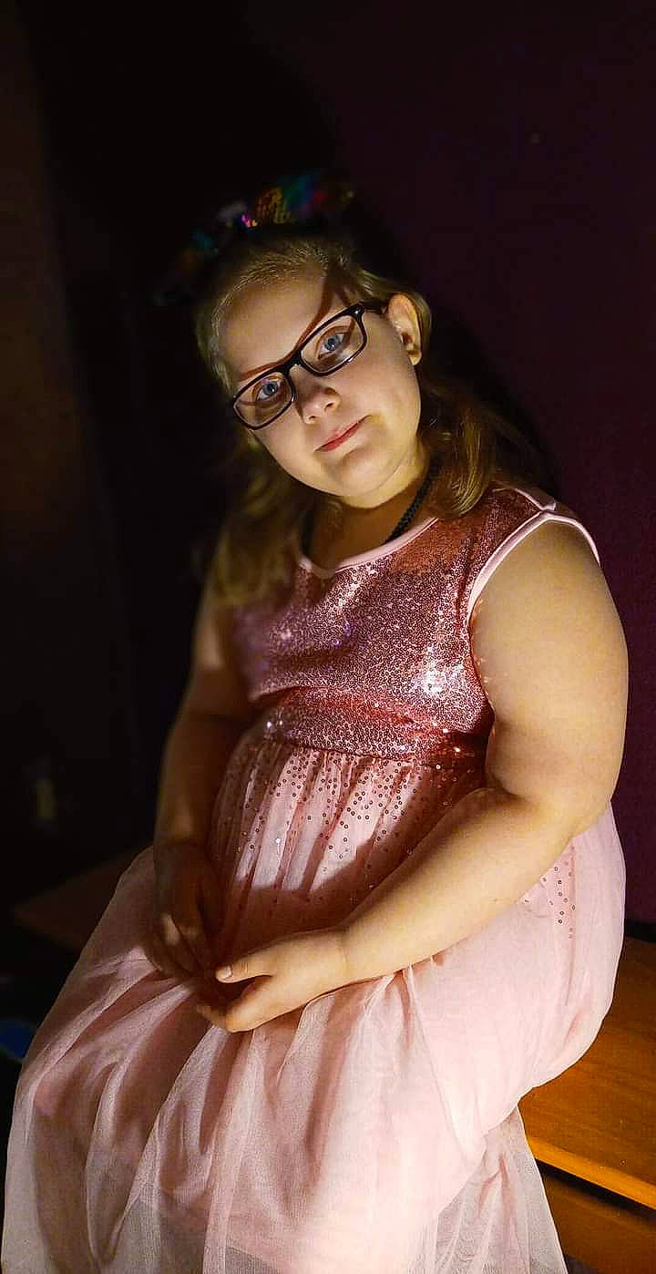 Caitlin is registered to the contest to win money with this photo: day_dress, dress, event, facial_expression, fashion_design, flash_photography, formal_wear, glasses, gown, hair, jewellery, long_hair, neck, necklace, one_piece_garment, person, pink, shoulder, skin, trunk