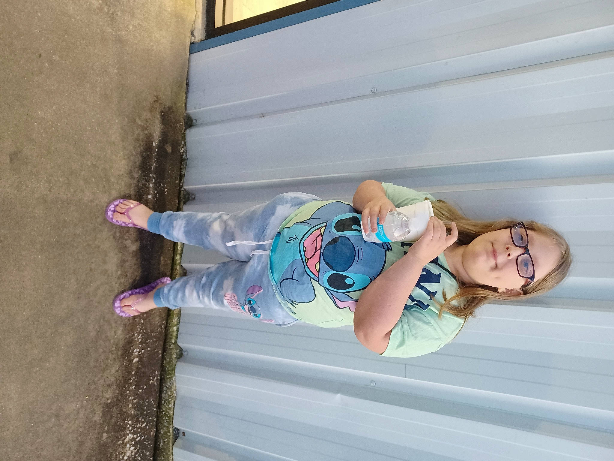 Caitlin is registered to the contest to win money with this photo: asphalt, baby_toddler_clothing, child, concrete, electric_blue, eyewear, fun, glasses, happy, hat, human_leg, leg, leisure, person, smile, thigh, toddler, walking_shoe