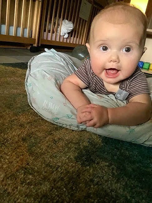 Oaklynn is registered to the contest to win money with this photo: baby, baby_toddler_clothing, cheek, child, comfort, crawling, flash_photography, flooring, foot, fun, gesture, grass, happy, nose, person, room, sitting, skin, smile, surprise