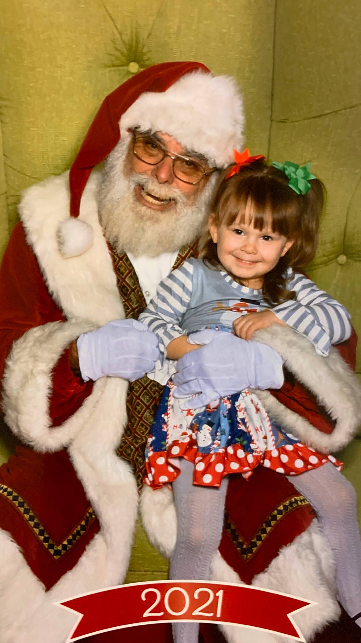 Waylynn is registered to the contest to win money with this photo: baby_toddler_clothing, beard, eye, face, fun, glasses, hair, happy, hat, head, headwear, human_body, joy, lap, organ, people, person, photograph, red, santa_claus