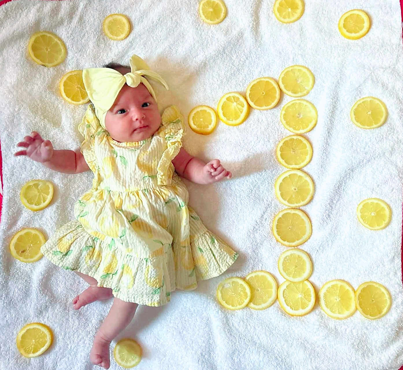 Ariana participe au concours pour gagner de l'argent avec cette photo : baby, infant, newborn, lemon, lemon_slices, towel, headband, yellow_dress, laying_down, blanket, soft_texture, one_number, props, cute, small_feet, arm, face, portrait, bright, flatlay