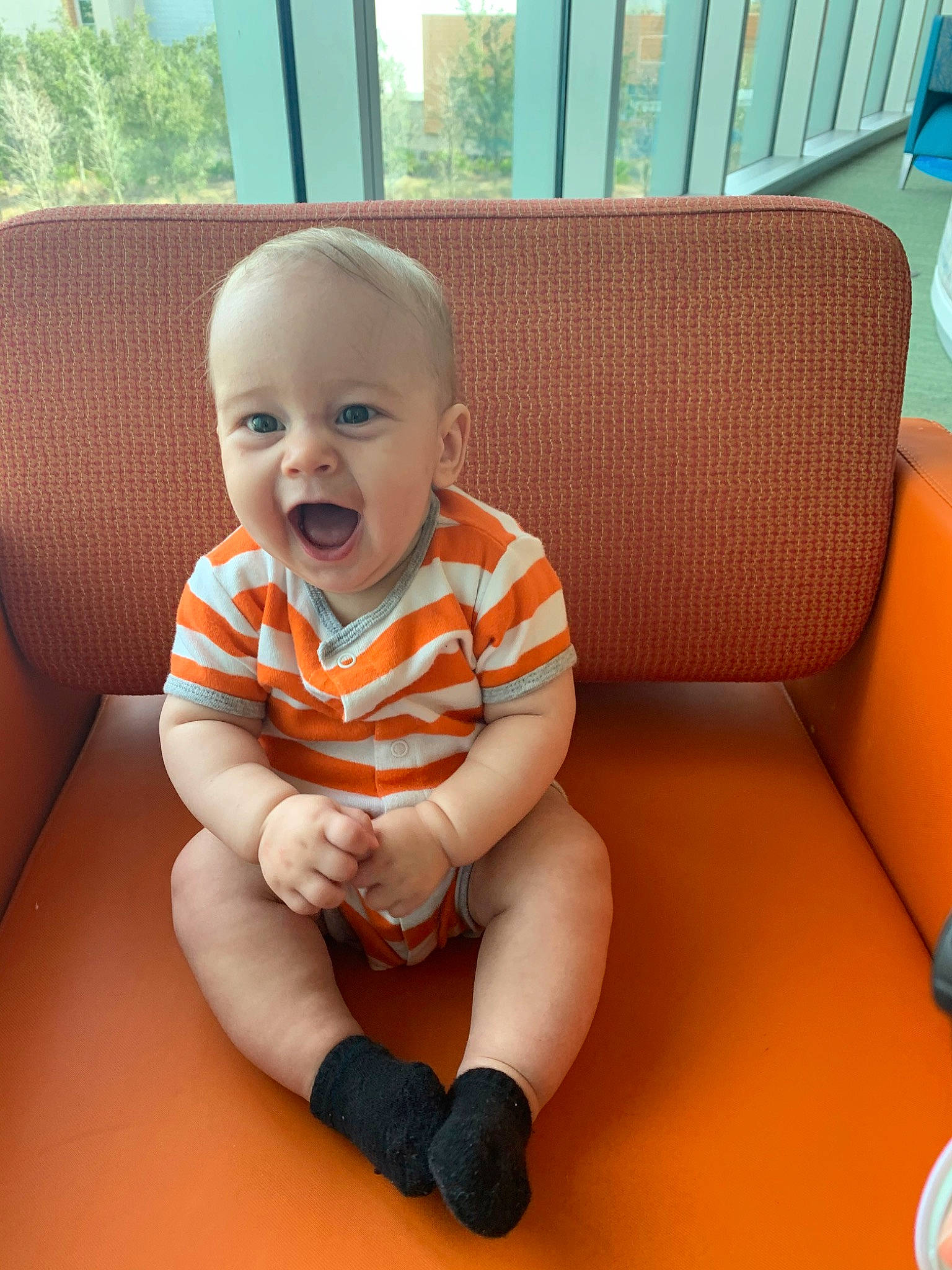 Zayne joined the competition — help win amazing prizes! baby, cheek, child, face, head, orange, person, sitting, skin, smile, toddler