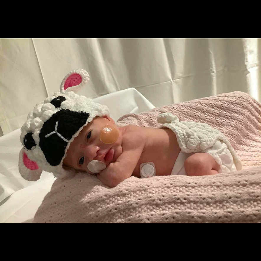 Dolcie-Rae is registered to the contest to win money with this photo: adorable, baby, blanket, child, cozy, crochet_hat, cute, headgear, indoors, infant, lamb_costume, lying_down, newborn, pink_blanket, portrait, resting, sleepy, small, soft_texture, wrapped