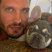 Mik joined the competition — help win amazing prizes! man, dog, french_bulldog, tattoo, tattooed_arm, portrait, selfie, face, close_up, bed, indoor, pet, snuggling, animal, cute, looking_at_camera, resting, skin, beard, ear