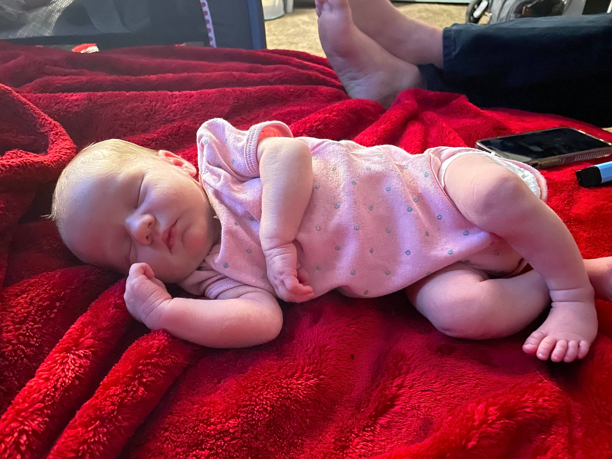 Brooklynne is registered to the contest to win money with this photo: baby, baby_toddler_clothing, cheek, child, comfort, facial_expression, finger, foot, grass, hand, human_leg, knee, lap, linens, mouth, person, pink, sitting, skin, thigh