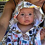 baby, child, towel, hood, animal_print, outdoor, person, adult, skin, face, eyes, hand, nature, greenery, sunlight, summer, portrait, candid, closeup, cute