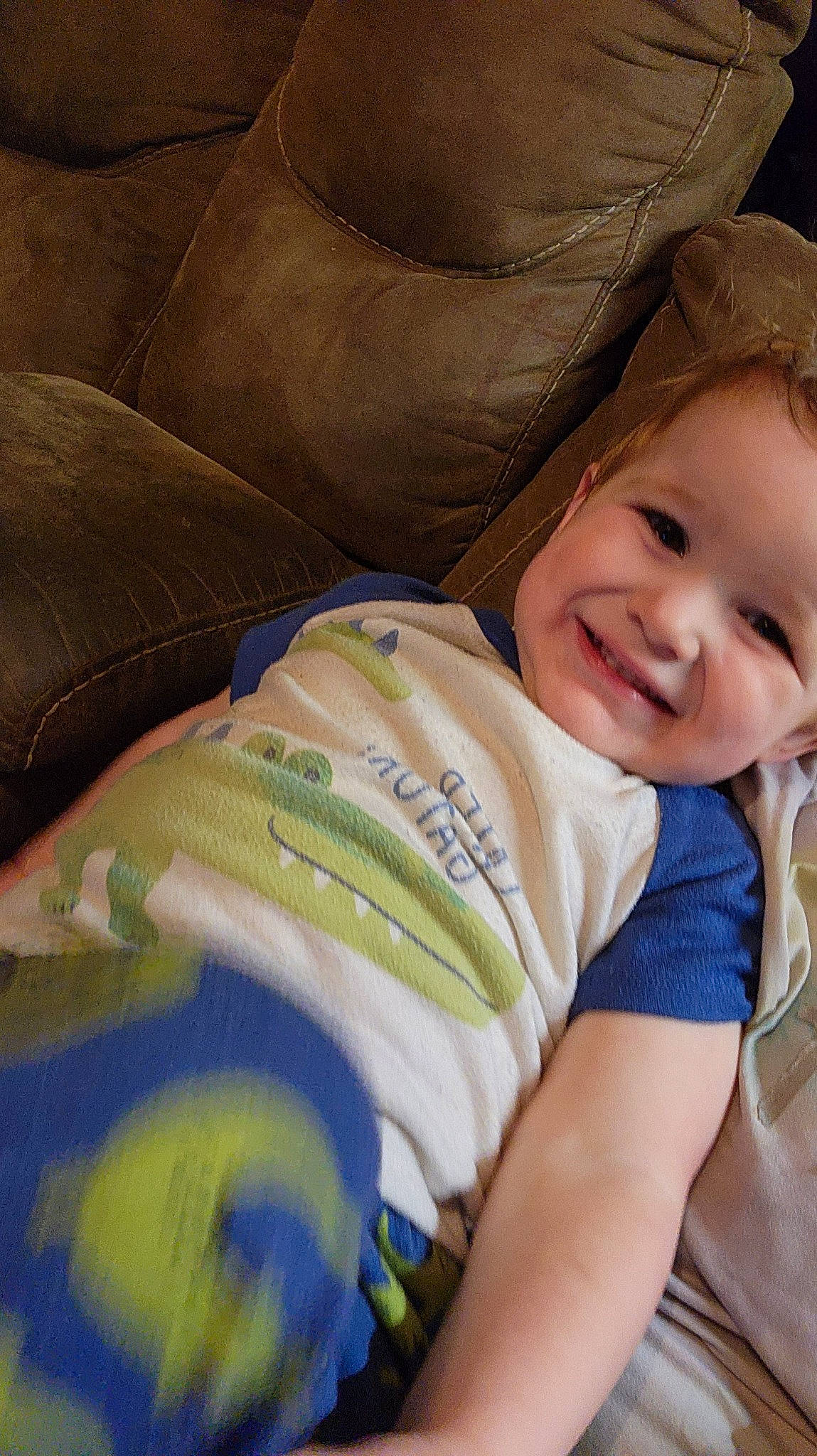 Myles is registered to the contest to win money with this photo: baby, baby_products, baby_toddler_clothing, cheek, child, comfort, couch, elbow, electric_blue, eyebrow, happy, human_body, iris, joy, linens, nose, person, sitting, skin, smile