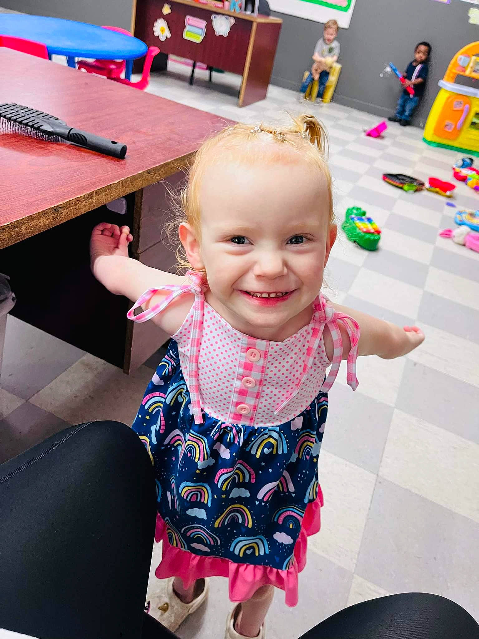 Maddie is registered to the contest to win money with this photo: baby, baby_toddler_clothing, blurred, chair, child, desk, event, finger, flooring, fun, happy, joy, leisure, pattern, person, pink, play, purple, room, sitting