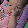 baby, infant, thumb_sucking, blanket, bib, close_up, face, child, cozy, soft_texture, pink, purple, cute, sleepy, resting, hand, skin, young_child, portrait, indoors