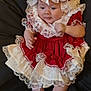 baby, infant, child, dress, lace, red_clothing, white_socks, cute, portrait, indoors, fabric, costume, adorable, laying_down, young_child, hands, feet, headwear, soft_texture, curious