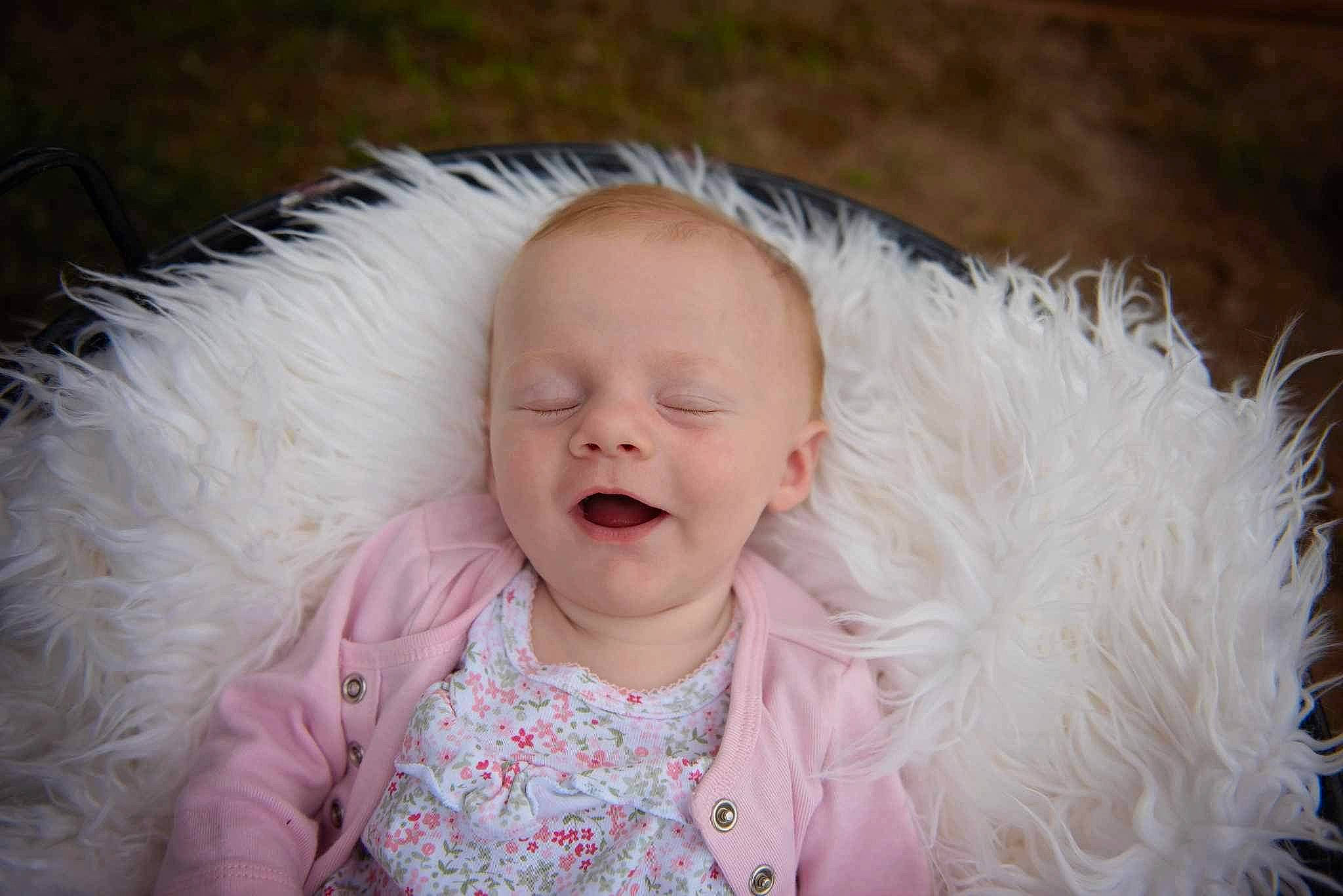 Zoey joined the competition — help win amazing prizes! baby, baby_laughing, baby_toddler_clothing, cheek, child, ear, eye, face, fashion_accessory, flash_photography, fur, fur_clothing, gesture, grass, happy, iris, laugh, person, pink, smile
