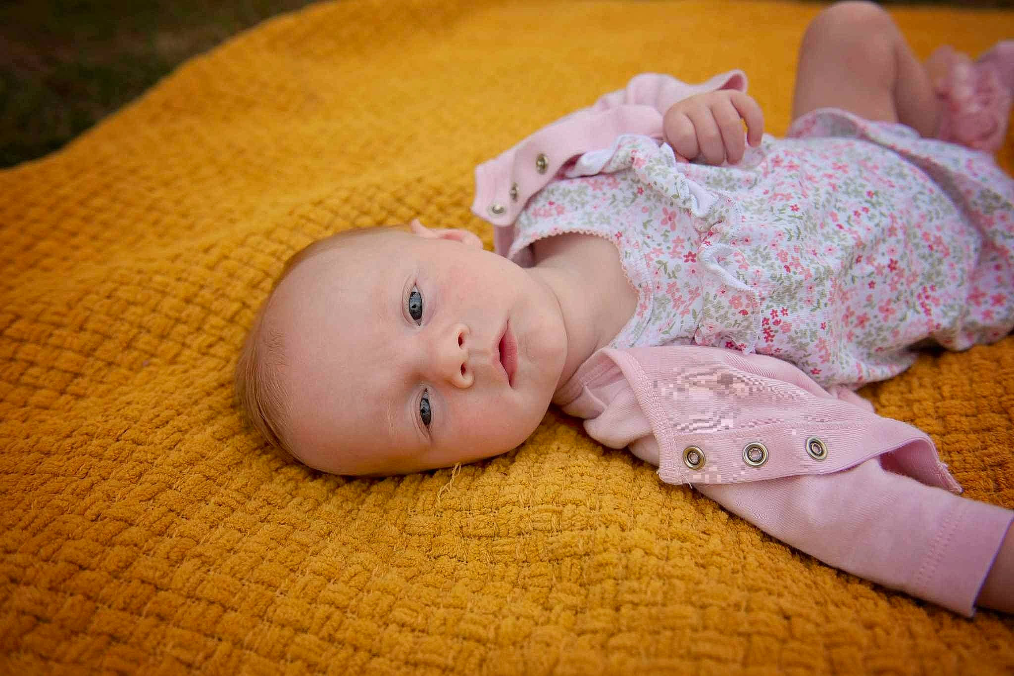 Zoey is registered to the contest to win money with this photo: baby, baby_toddler_clothing, cheek, child, comfort, flooring, grass, headgear, linens, pattern, person, portrait_photography, sitting, skin, sleep, sleeve, toddler, wood