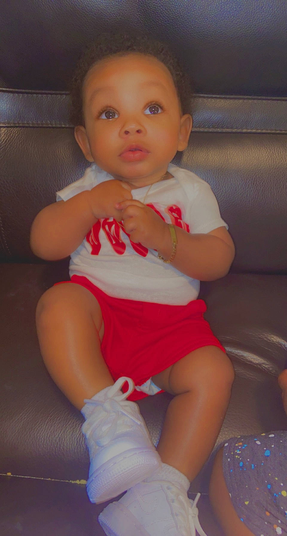 Amiri is registered to the contest to win money with this photo: arm, baby_toddler_clothing, cheek, comfort, eye, finger, head, iris, joint, knee, lap, leg, lip, mouth, neck, person, pink, skin, thigh, thumb