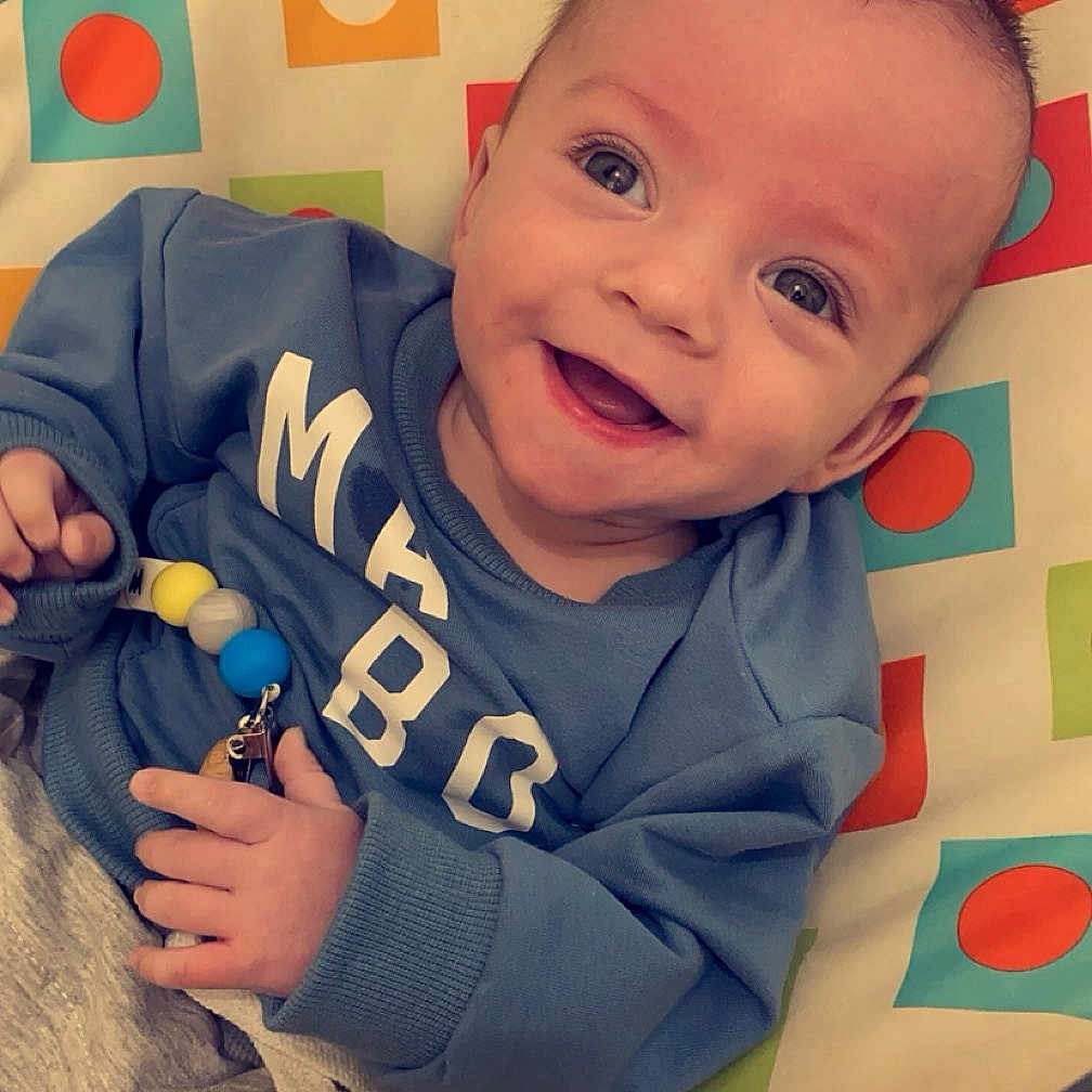 Waylon joined the competition — help win amazing prizes! baby, bed, blanket, clothing, couch, cushion, cutlery, face, furniture, happy, head, homedecor, laughing, person, photography, portrait, quilt, smile, spoon, t_shirt