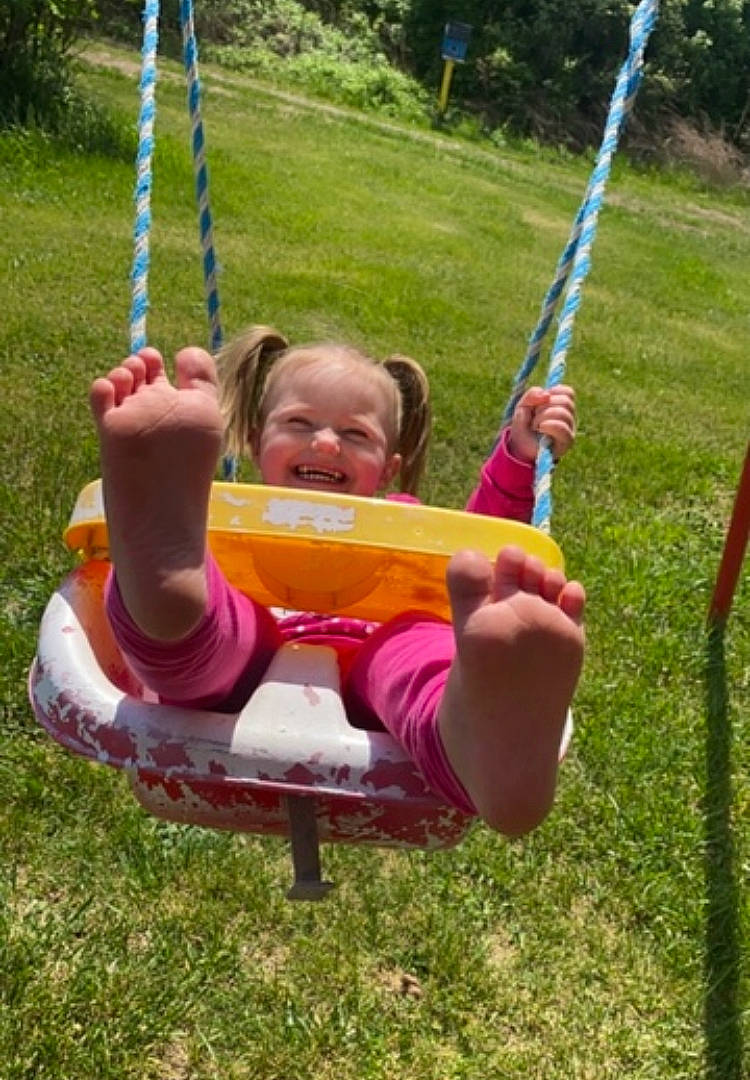 Eva joined the competition — help win amazing prizes! baby_toddler_clothing, balance, child, city, fun, grass, happy, leisure, outdoor_play_equipment, people_in_nature, person, plant, play, playground, recreation, shorts, smile, swing, toddler, tree