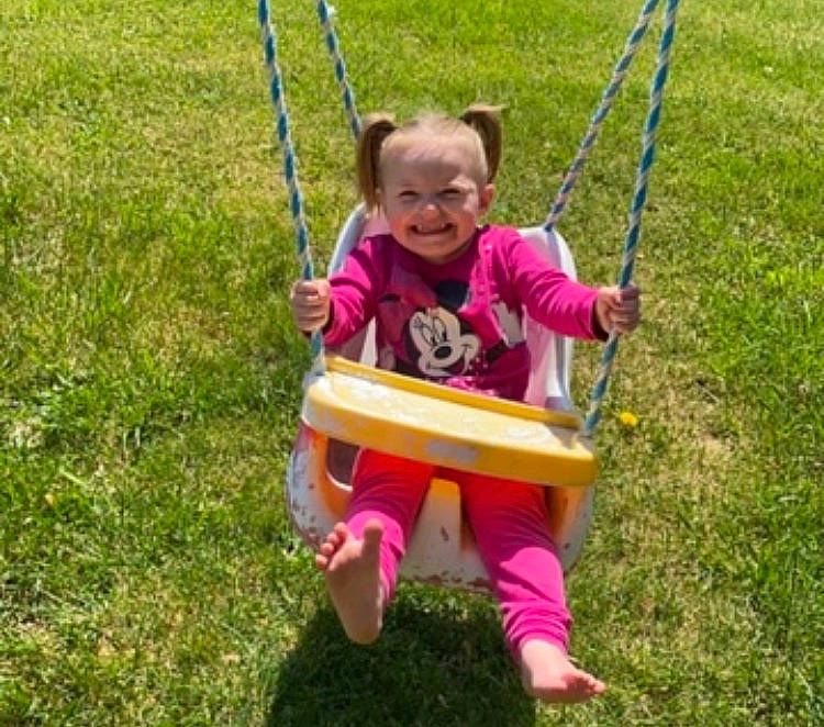 Eva joined the competition — help win amazing prizes! child, city, fun, grass, grassland, happy, joy, lawn, leisure, outdoor_play_equipment, people_in_nature, person, plant, play, playground, recreation, sitting, smile, sunglasses, swing