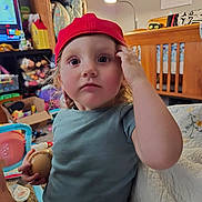 Ryker joined the competition — help win amazing prizes! toddler, child, red_cap, baseball, indoor, room, crib, toy, shelf, furniture, curious, person, clothing, face, hand, expression, play, quilt, lamp, calendar
