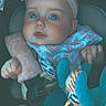 baby, infant, car_seat, headband, bib, plush_toy, child, straps, soft_cushion, curious, wide_eyes, indoor, seatbelt, cute, small_hands, colorful_toy, young_child, portrait, close_up, safety