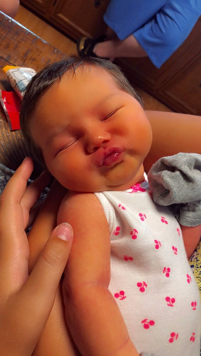 Rylie is registered to the contest to win money with this photo: baby, baby_toddler_clothing, cheek, chin, ear, eyelash, facial_expression, finger, gesture, hand, happy, head, lip, mammal, mouth, neck, nose, person, pink, skin