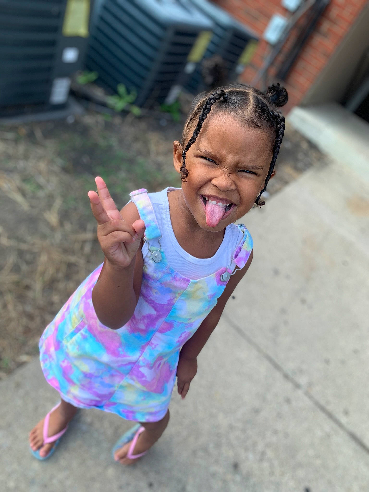 Arie is registered to the contest to win money with this photo: anger, baby_toddler_clothing, child, chin, event, eyewear, facial_expression, fun, grass, happy, leisure, magenta, person, pink, plant, recreation, sitting, sleeve, smile, t_shirt