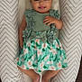 baby, infant, child, smiling, dress, headband, bow, floral, pattern, cushion, lounger, chevron_pattern, fabric, feet, hand, person, cute, happy, indoors, lying_down