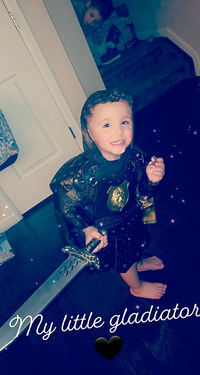 Manny joined the competition — help win amazing prizes! blue, chair, child, electric_blue, flash_photography, formal_wear, fun, happy, headwear, joy, pattern, person, personal_protective_equipment, photo_caption, portrait_photography, room, sitting, sleeve, smile, standing