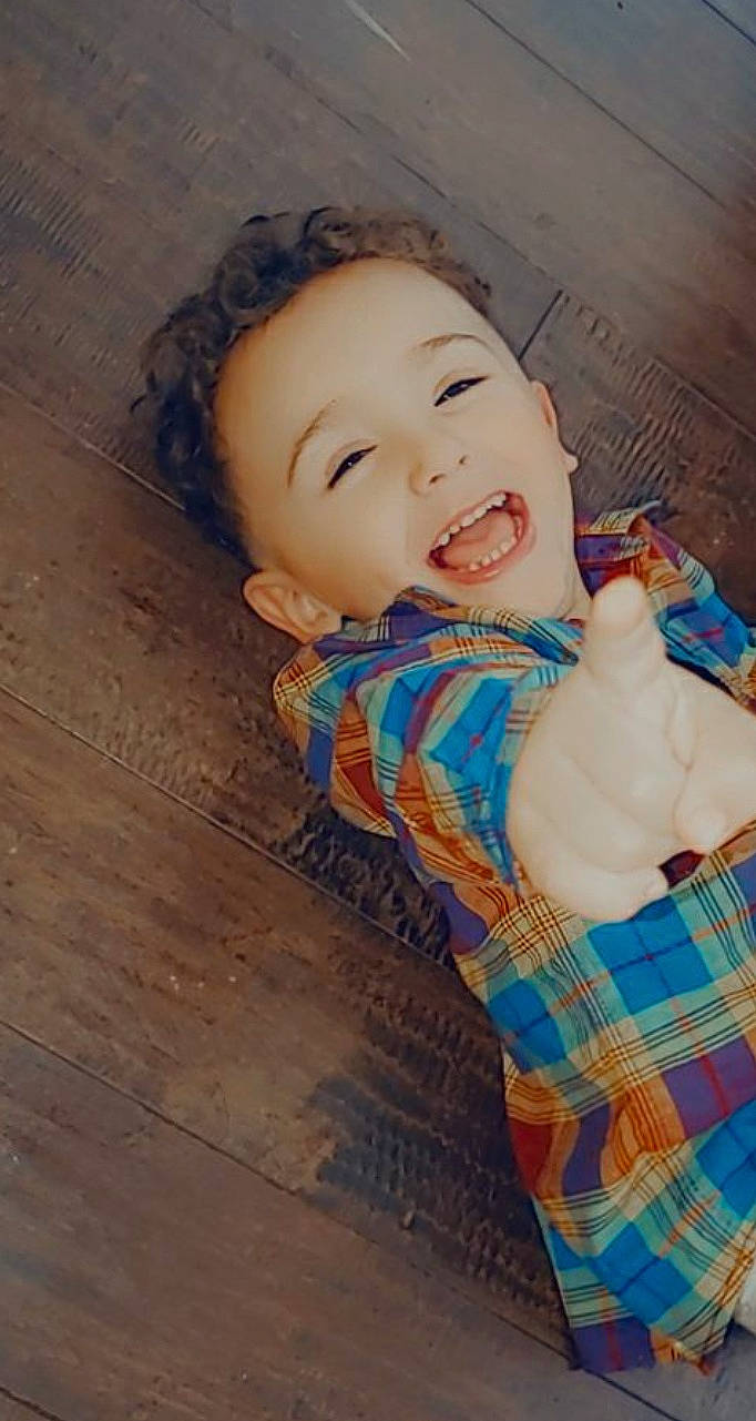 Manny is registered to the contest to win money with this photo: baby, baby_laughing, baby_products, baby_toddler_clothing, cheek, child, finger, floor, flooring, hardwood, laminate_flooring, laugh, nose, person, thumb, toddler, tongue, tooth, wood_flooring, wood_stain