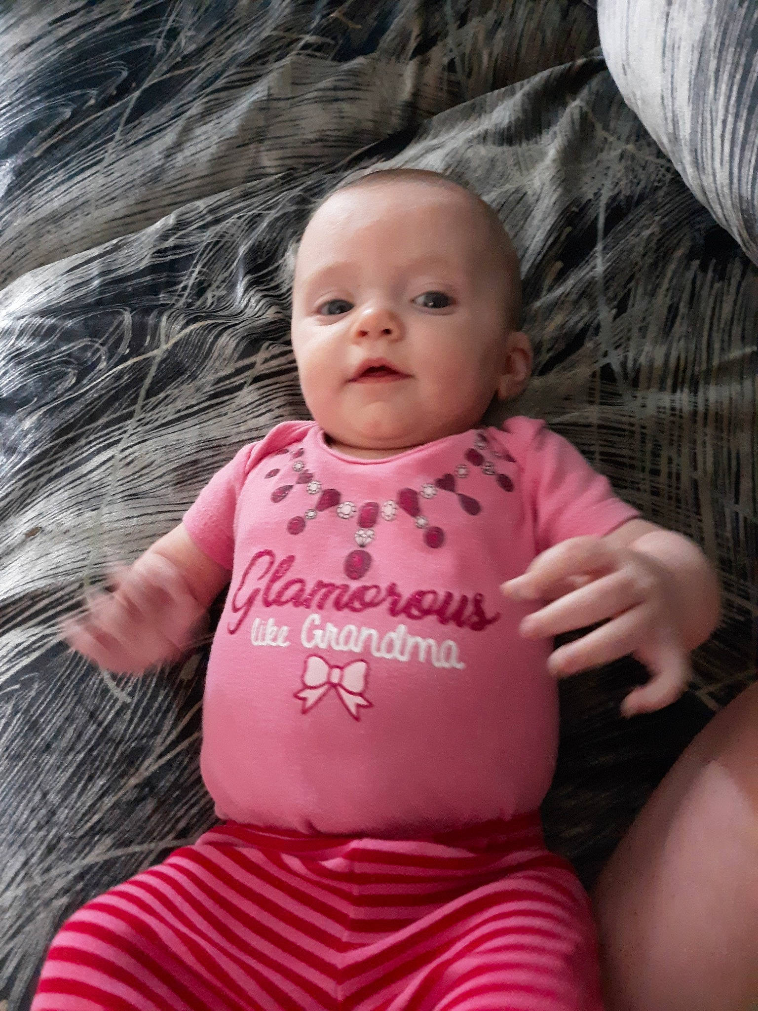 Cara is registered to the contest to win money with this photo: baby, baby_products, baby_toddler_clothing, cheek, child, eye, face, lip, person, pink, sitting, skin, toddler