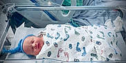 Davian joined the competition — help win amazing prizes! newborn, baby, hospital, bassinet, blanket, blue_hat, swaddled, sleeping, medical_equipment, bed, infant, footprints, person, healthcare, patient, cute, peaceful, indoors, resting, nursery