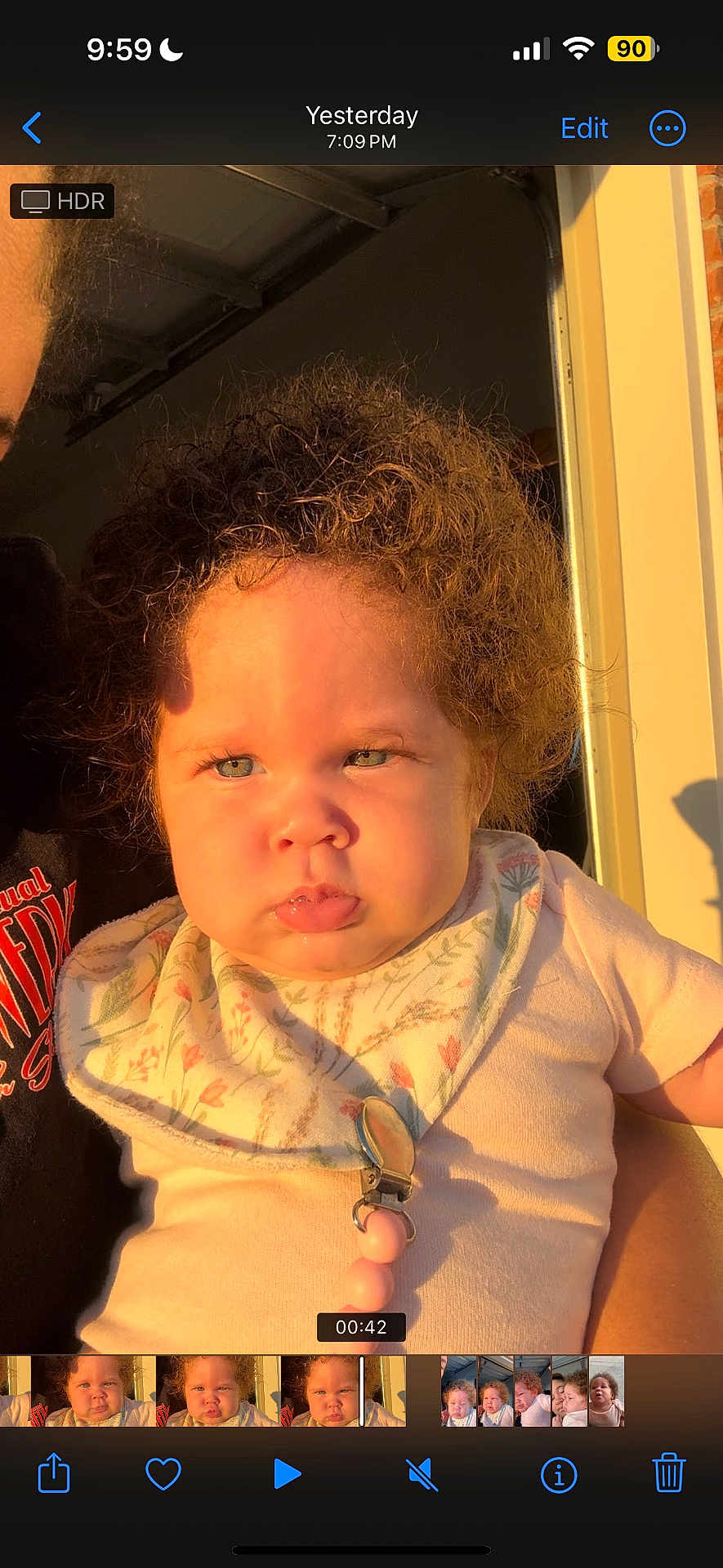 Jalaya is registered to the contest to win money with this photo: baby, child, curly_hair, bib, sunlight, portrait, face, expression, indoors, doorway, clothing, person, cute, infant, holding, skin, cheeks, young, serious, light