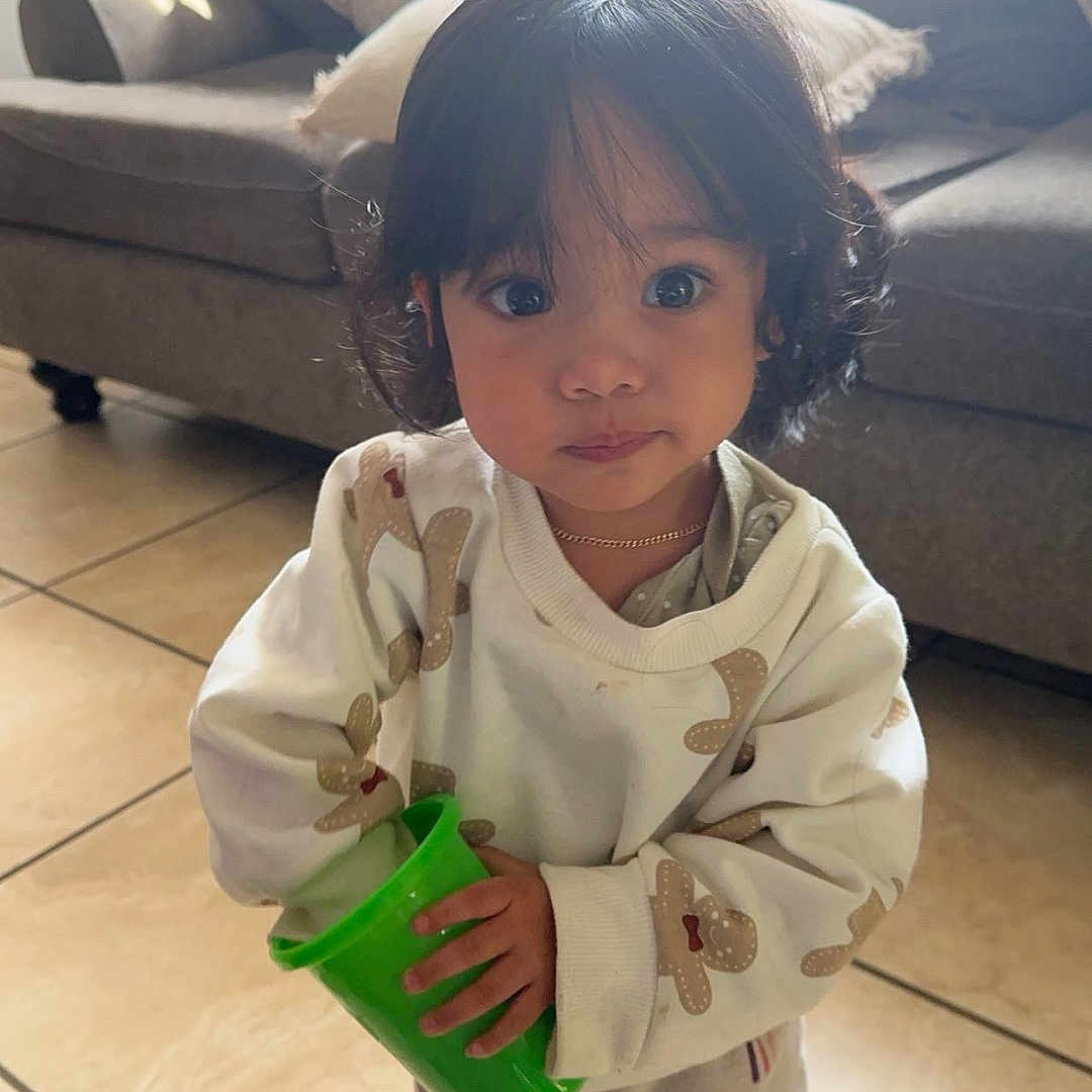 Celeste is registered to the contest to win money with this photo: architecture, building, child, clothing, coat, couch, cushion, face, female, furniture, girl, head, homedecor, indoors, interiordesign, livingroom, person, photography, portrait, room