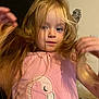 Amelia-Mae is registered to the contest to win money with this photo: child, blonde_hair, pink_shirt, flamingo_design, indoor, portrait, young_child, hands, hair, cute, cozy, casual_clothing, person, face, curious, motion, soft_lighting, wall, bed, home