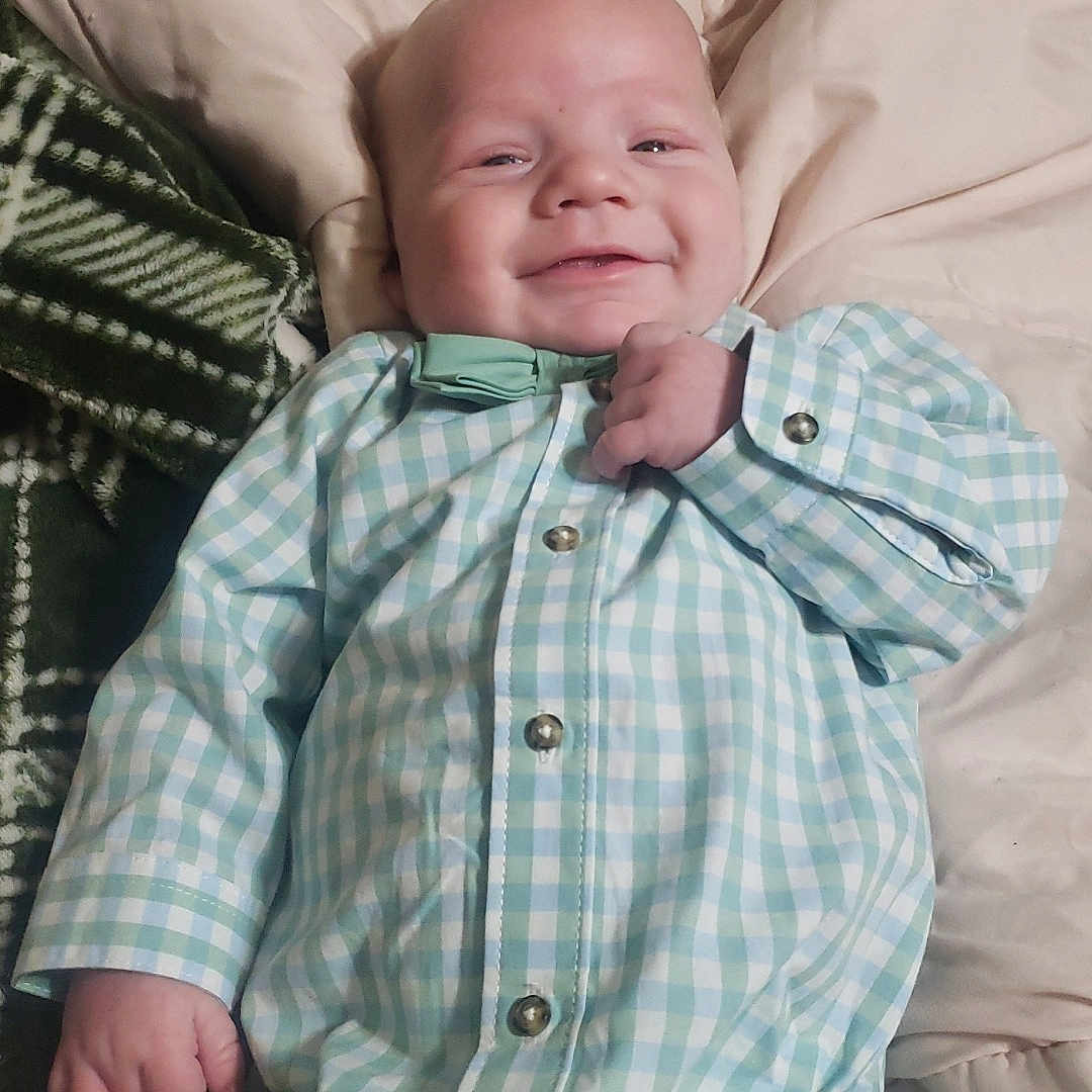 Finn is registered to the contest to win money with this photo: baby, bed, bedroom, clothing, couch, cushion, face, furniture, happy, head, homedecor, indoors, linen, newborn, pants, person, photography, portrait, shirt, smile