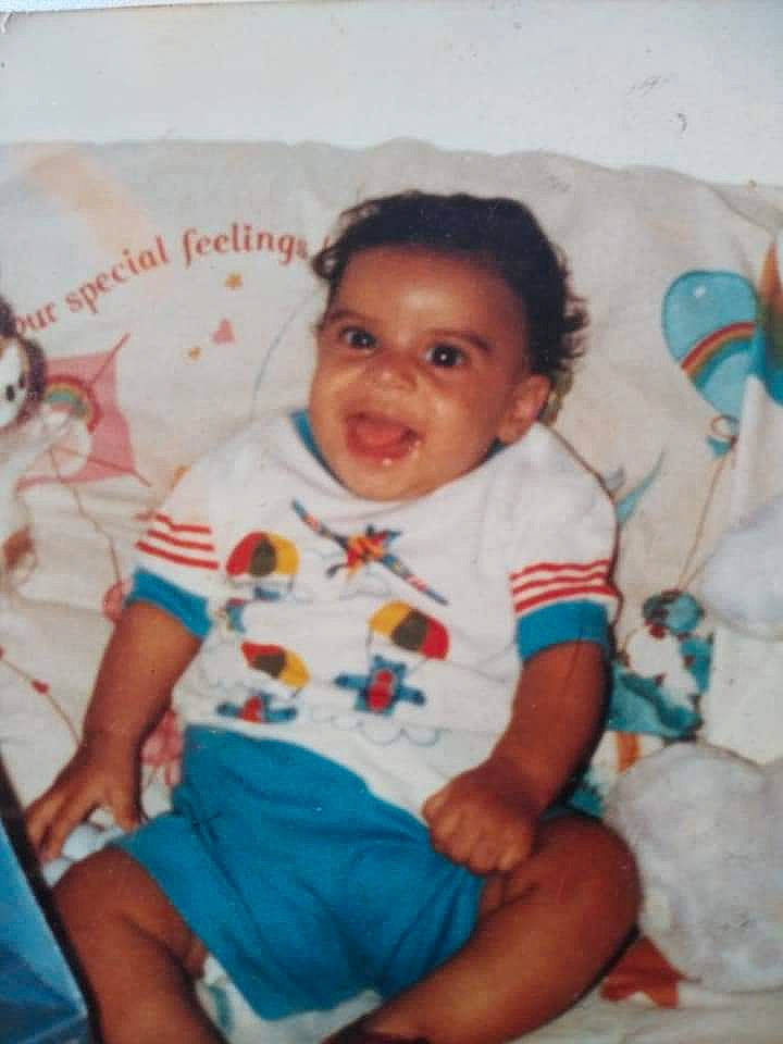 Ricardo Rivera joined the competition — help win amazing prizes! baby, baby_toddler_clothing, cheek, child, comfort, eye, facial_expression, fun, happy, iris, joy, linens, pattern, person, room, sitting, skin, sleeve, smile, t_shirt