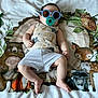 Peter joined the competition — help win amazing prizes! baby, blanket, pacifier, sunglasses, infant, cute, animal_print, bed, sleepwear, child, relaxing, indoor, soft, comfort, portrait, toddler, clothing, toy, smile, resting