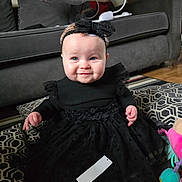 Nancy-Rose is registered to the contest to win money with this photo: architecture, baby, bodypart, building, clothing, couch, cushion, dress, face, formalwear, furniture, head, homedecor, indoors, livingroom, person, photography, portrait, room, sitting