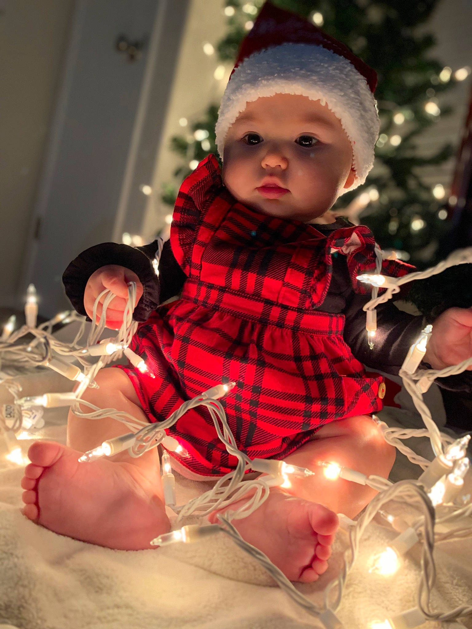 Riverlynn is registered to the contest to win money with this photo: baby, baby_toddler_clothing, child, christmas, christmas_eve, christmas_ornament, event, fashion, fashion_accessory, fictional_character, fun, happy, head, headwear, holiday, human_body, pattern, person, pink, sitting