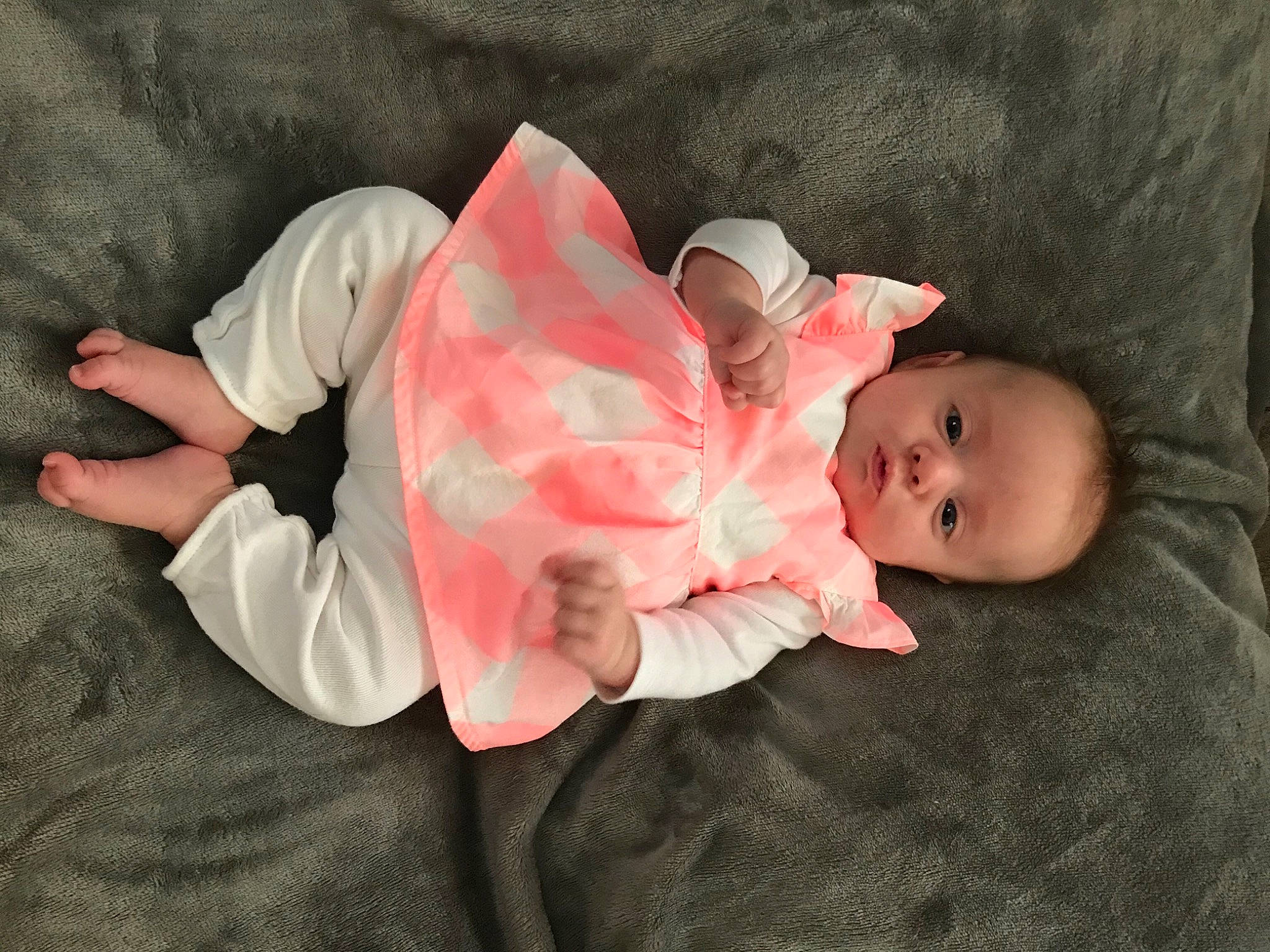 Emmalynn joined the competition — help win amazing prizes! baby, baby_products, baby_toddler_clothing, cheek, comfort, dress, finger, flooring, grass, headgear, human_body, linens, person, pink, plant, sitting, skin, sleeve, textile, toddler