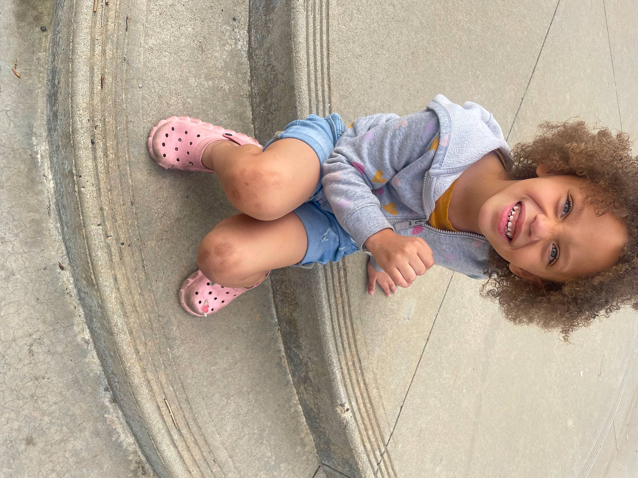 Paris joined the competition — help win amazing prizes! asphalt, automotive_tire, concrete, denim, electric_blue, eye, eyewear, foot, grass, human_leg, joy, knee, leg, leisure, person, road_surface, sidewalk, smile, sneakers, thigh