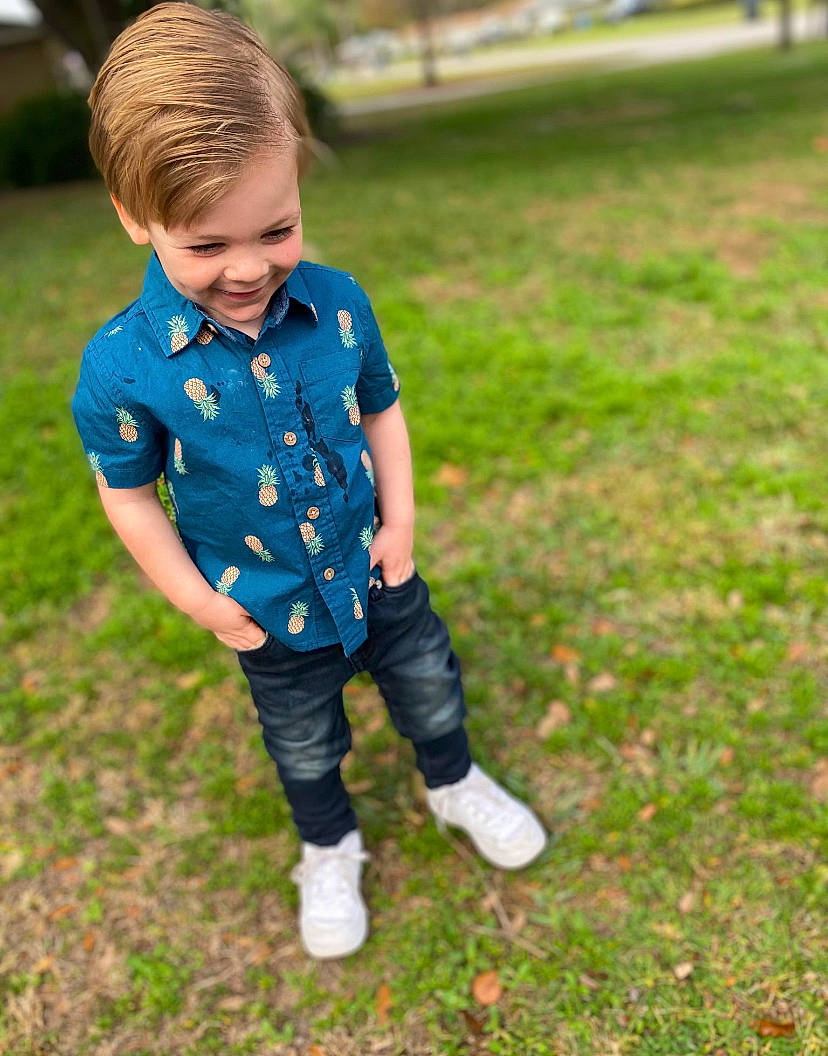 Miller is registered to the contest to win money with this photo: baby, baby_toddler_clothing, child, denim, electric_blue, face, grass, grassland, happy, joy, lawn, leisure, pattern, people_in_nature, person, plant, recreation, sleeve, smile, t_shirt