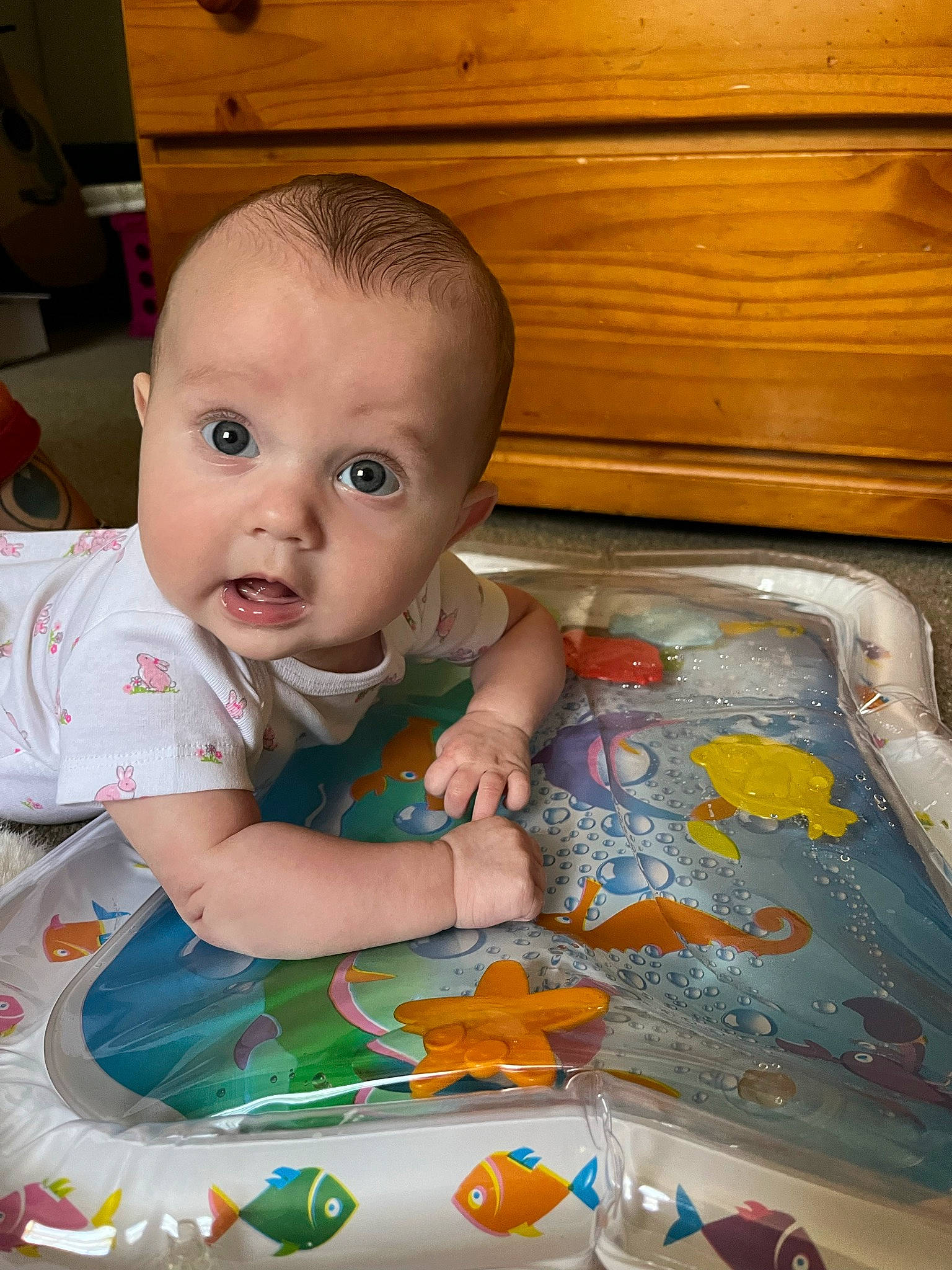 Amelia joined the competition — help win amazing prizes! arm, baby, baby_products, baby_toddler_clothing, cheek, child, eye, flooring, fun, hardwood, iris, mouth, nose, person, play, product, room, sitting, surprise, toddler