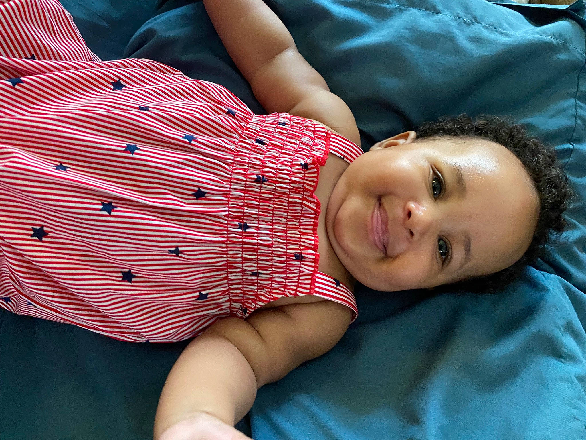 Armani is registered to the contest to win money with this photo: abdomen, arm, baby_toddler_clothing, chest, child, comfort, couch, elbow, flash_photography, happy, human_body, human_leg, joy, lip, mouth, person, plaid, skin, smile, thigh