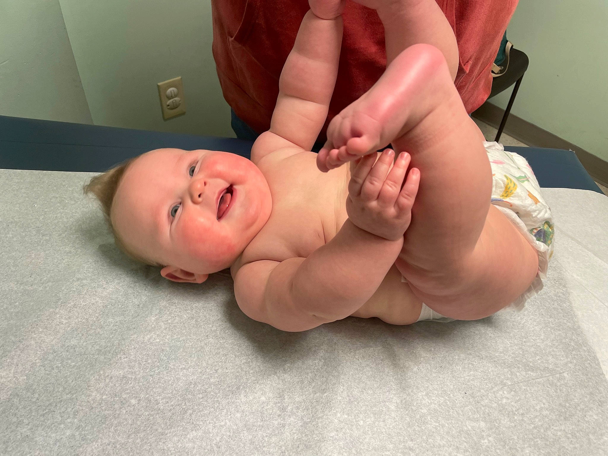 Everett is registered to the contest to win money with this photo: abdomen, baby, baby_toddler_clothing, child, comfort, finger, foot, gesture, hand, human_leg, knee, mouth, nail, person, service, skin, smile, stomach, thigh, thumb