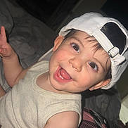 Thiago Alvarino joined the competition — help win amazing prizes! toddler, child, smiling, happy, cap, hat, indoor, bed, blanket, pattern, clothing, person, cute, portrait, young_child, face, eyes, skin, sleeveless_shirt, playful