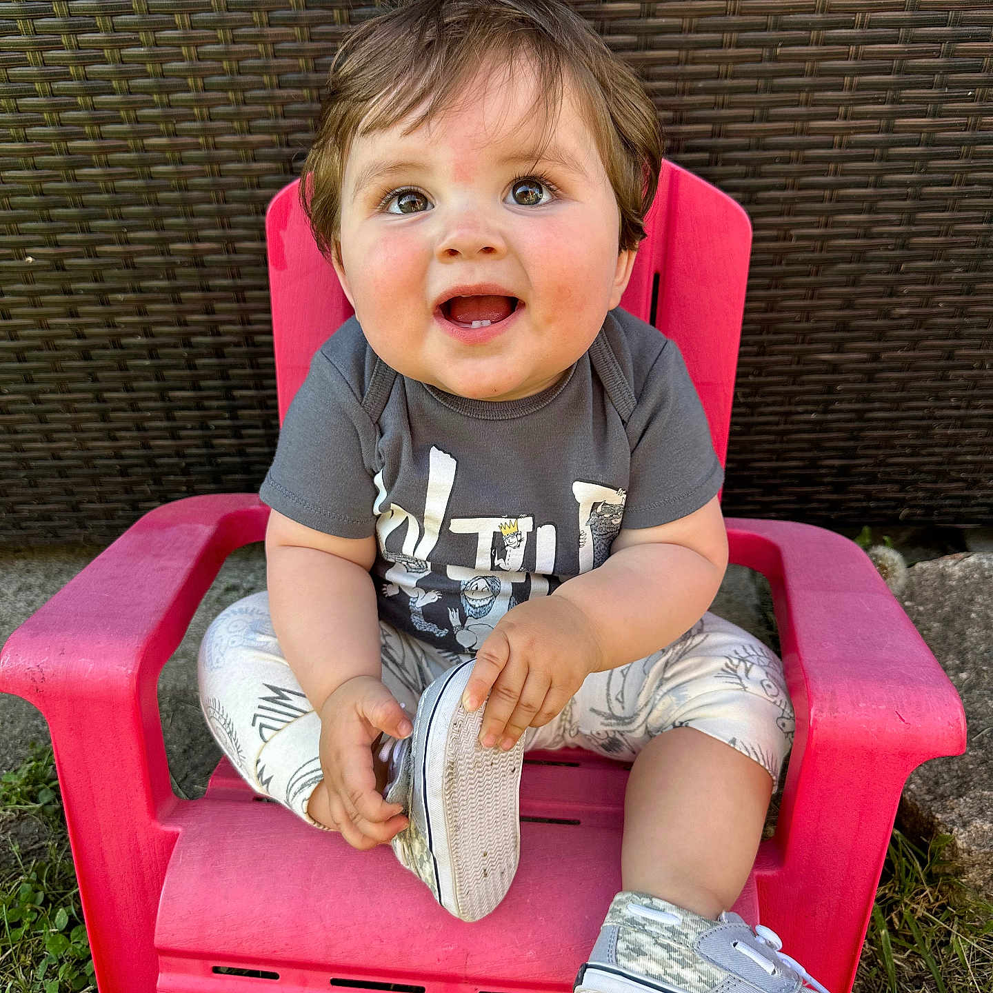 Hayden is registered to the contest to win money with this photo: baby, ball, chair, clothing, face, footwear, furniture, grass, head, pants, person, photography, plant, portrait, sandal, shoe, shorts, sitting, sneaker, t_shirt