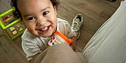 Esau joined the competition — help win amazing prizes! bright, candid, casual, child, clothing, container, curly_hair, floor, happy, holding, indoor, living_room, person, playful, shoe, smiling, toddler, toy, wooden_floor, young_child