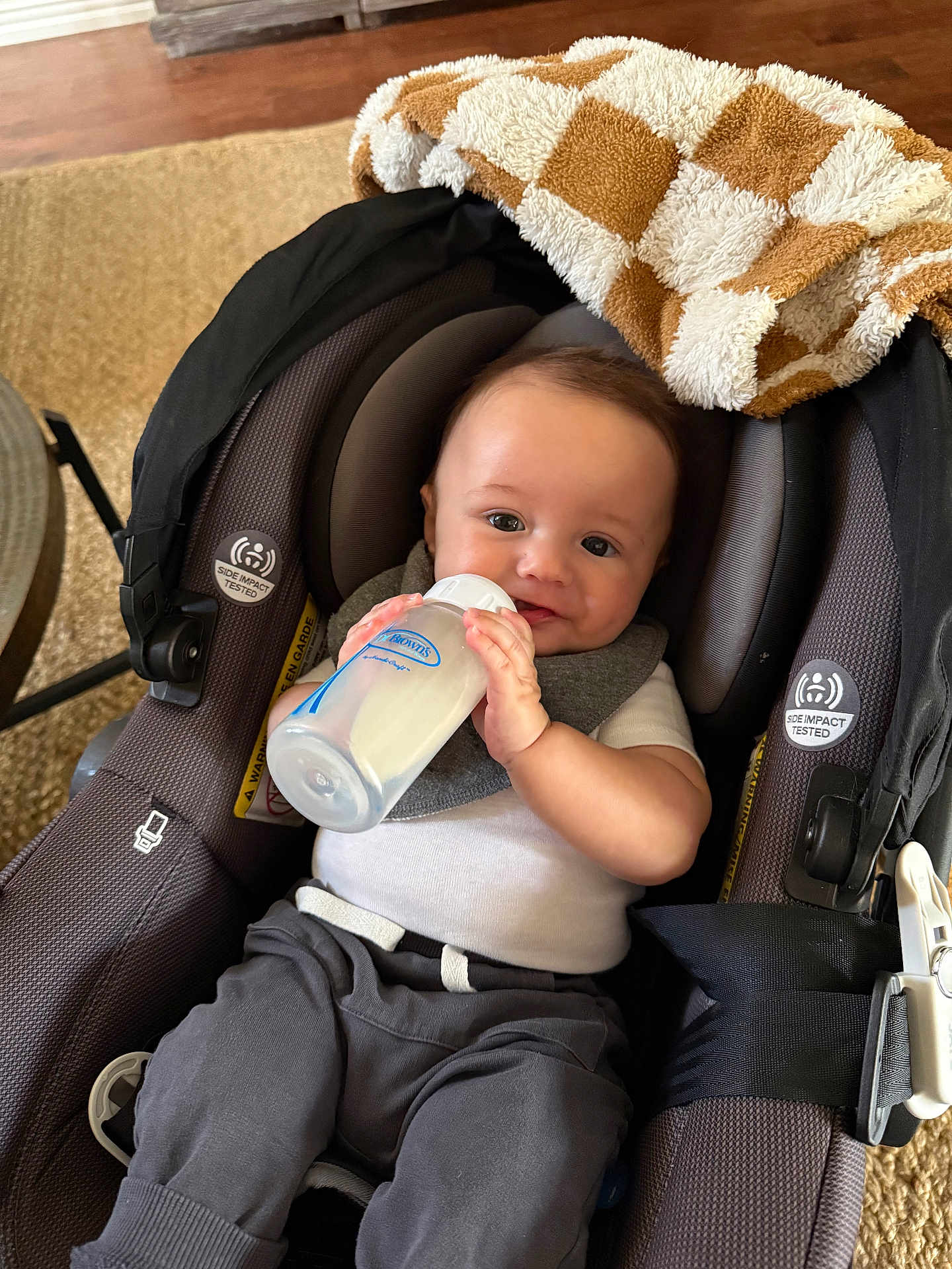 Statham joined the competition — help win amazing prizes! baby, infant, car_seat, milk_bottle, blanket, clothing, smiling, face, person, indoor, seatbelt, fabric, home, comfort, child, feeding, cute, young_child, happy, casual