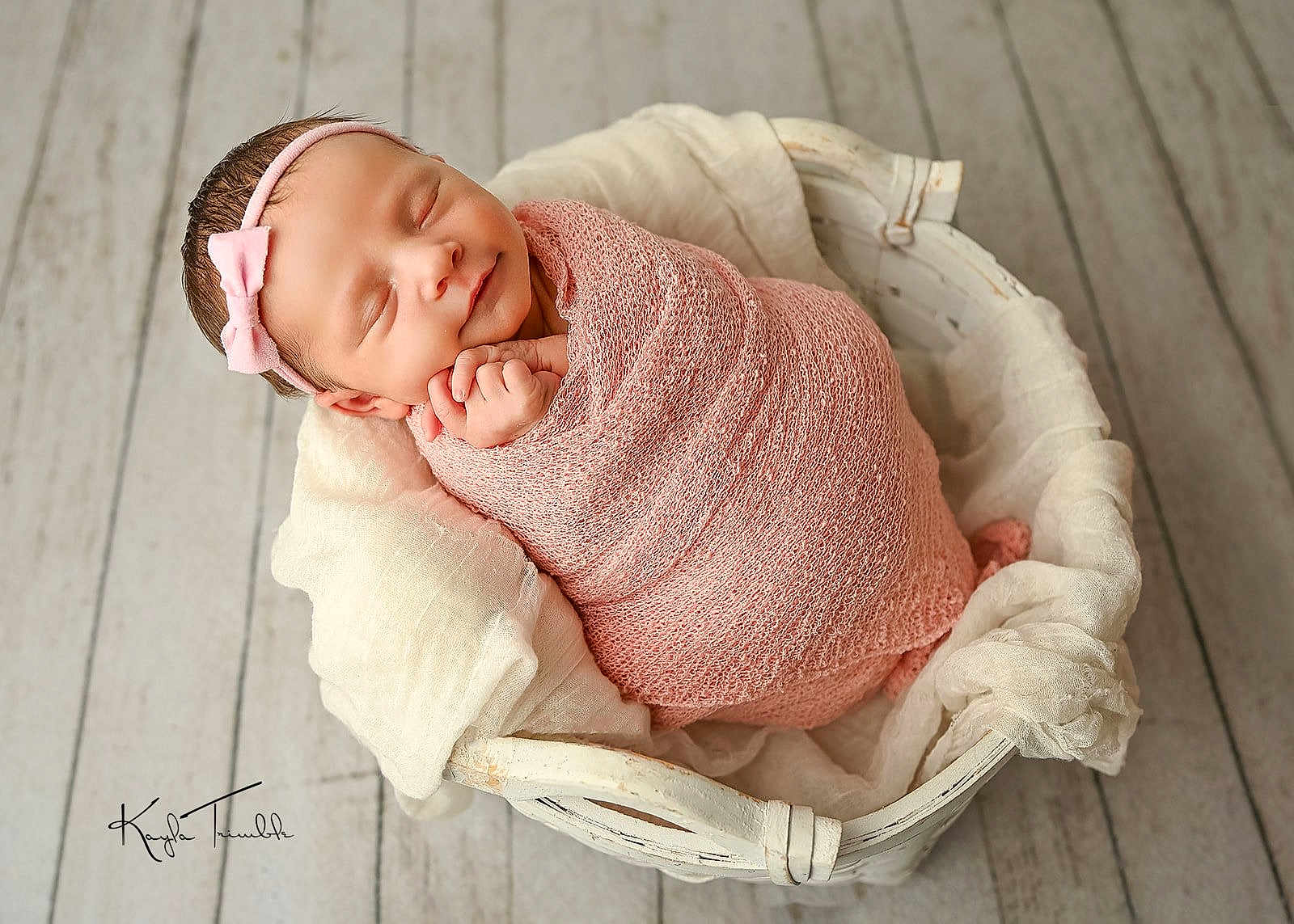 Daisy-Mae joined the competition — help win amazing prizes! newborn, baby, sleeping, wrapped, pink_wrap, headband, basket, white_basket, wooden_floor, soft_blanket, peaceful, infant, cute, portrait, indoors, resting, tiny_hands, headband_bow, cozy, newborn_photography